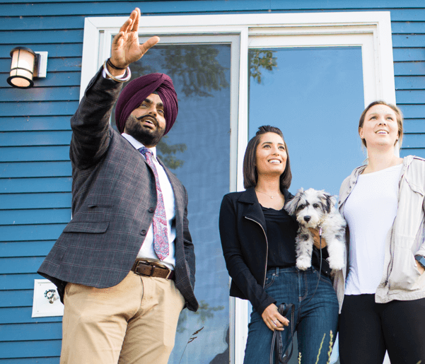 Realtor showing two women and their dog a property.